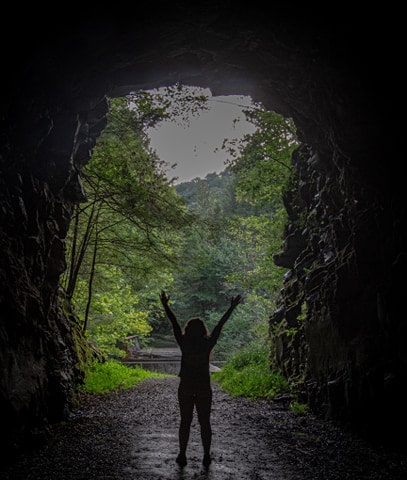 Standing inside the formed L&N tunnel off of the Clear Creek Fitness Trail. If you look closely you can see what remains of one of the four trestle bridges on the trail. 