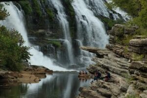 Lots of people enjoying what Rock Islands Twin Falls has to offer. A well photographed Tennessee waterfall.